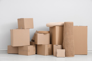 Many different parcels and pillow near white wall in room