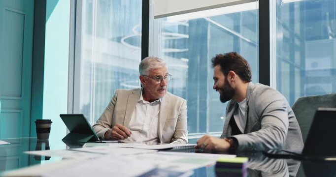 Tablet, mentor and business men talking for financial training, planning and discussion. Teamwork, technology and manager coaching intern in office for investment meeting, help and project feedback
