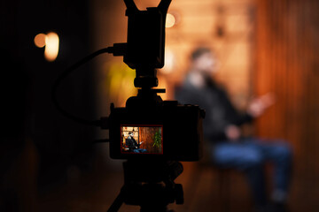 Interview setup with a guy speaking on camera in a podcast-style filming environment