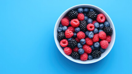 vibrant bowl of mixed berries including raspberries, blueberries, and blackberries, perfect for healthy snack