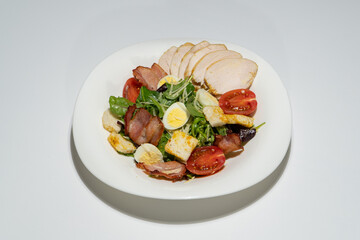 Fresh Salad Plate with Grilled Chicken, Bacon, Quail Eggs, Tomatoes, Croutons, and Mixed Greens © Galka3250