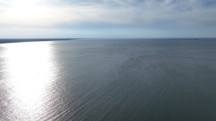 Obraz premium Chesapeake Bay at Virginia Beach, VA showing bridge and tunnel on horizon on a clam peaceful day traveling the coastline