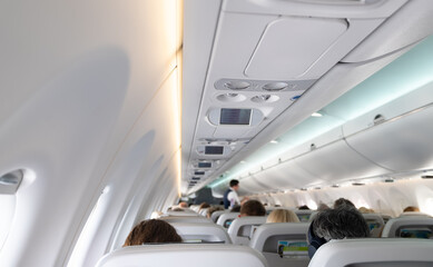 Interior inside of the plane with passengers.
