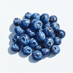 A close up shot of a pile of fresh blueberries on a white surface in bright lighting conditions today