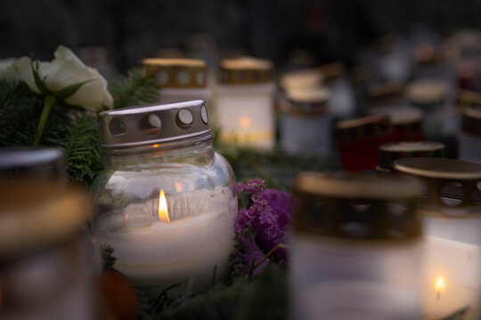Burning candle in jars kept on graves