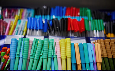 Pens display with various colors and designs in stationery store