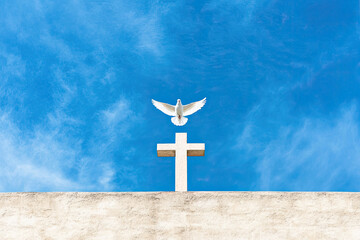 A white dove descends upon a simple cross against a vibrant blue sky, symbolizing peace, faith, and hope in a serene and uplifting moment.