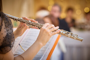 Flutist Performing at Event with Sheet Music