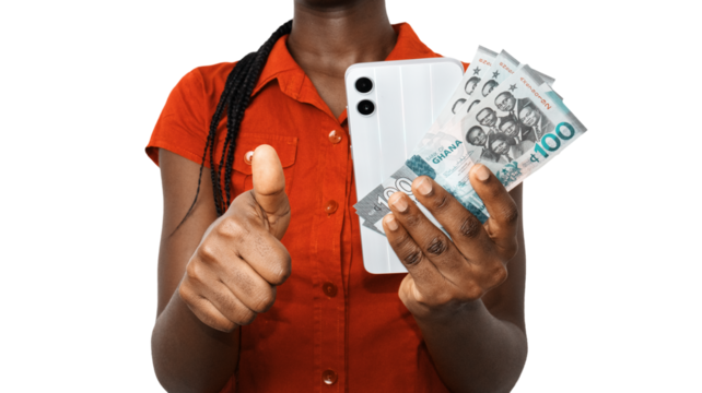 Young Black African lady woman wearing  Red orange shirt holding pointing showing mobile phone,Ghana Cedis notes and making thumbs up to camera over transparent background. 
