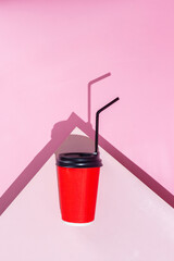 paper cup of coffee on pink background