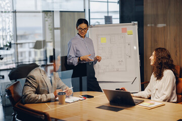 A diverse team actively discusses strategies during a highly productive presentation in a modern...