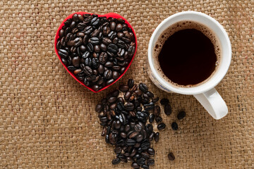 Coffee cup coffee beans on wooden table..