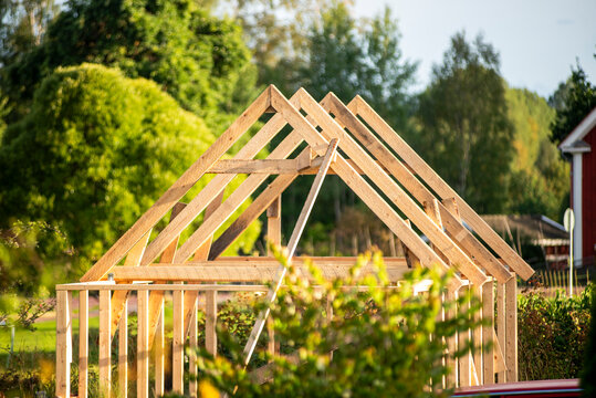 Incomplete wooden construction frame of house at sunny day