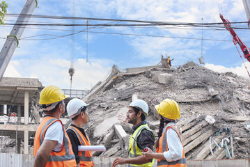 Group of construction engineers evaluates structural damage at a collapsed building site during...