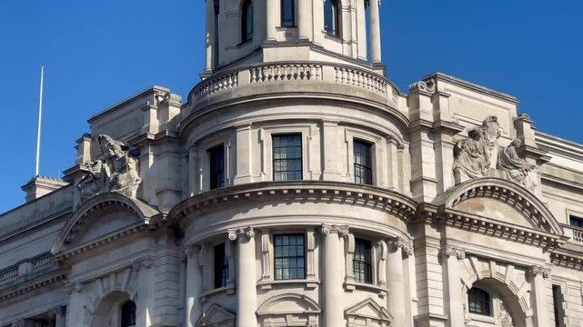 Elegant Baroque style government buildings in central London, gleaming under a crisp blue sky on a sunny day