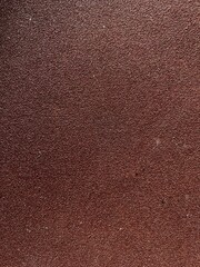 Fototapeta premium Red texture rough surface, sandpaper, abstract background. close up view.