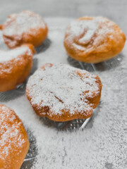 Freshly baked baursaki sprinkled with powdered sugar in prague