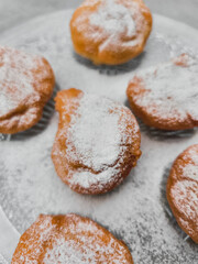 Traditional czech baursaki being sprinkled with icing sugar in prague