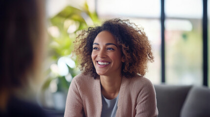 A therapist and client enjoy a joyful exchange in a warm and welcoming office, showcasing the positive atmosphere of their session together.