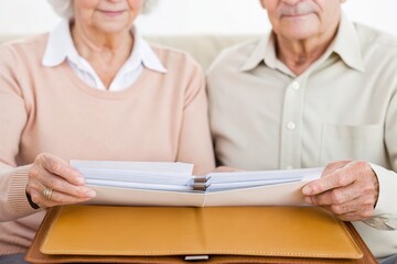 Obraz premium Senior finance concept. Elderly couple sharing moments while looking through a photo album together.