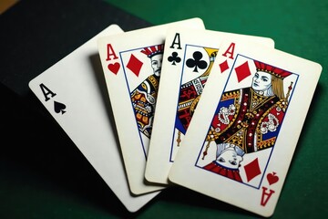 Four aces fanned out, showcasing their intricate designs , spread, close-up