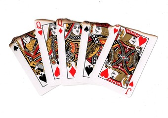 A poker hand of partly burnt playing cards.