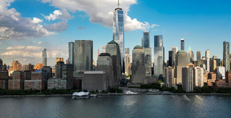 Fototapeta premium New York City an sky with clouds. NYC cityscape with skyscrapers. Aerial panorama of New York City skyline. Manhattan skyline. New York and Hudson River. Downtown NYC. New York skyscrapers from above.