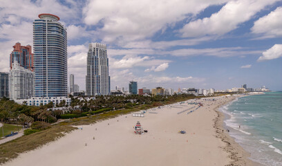 Beach in Miami with sunbed on a sandy beach with ocean waves. Miami Beach paradise with stunning views. South Beach Miami lifeguard post. Peaceful seaside retreat in Miami. Coastal relaxation.