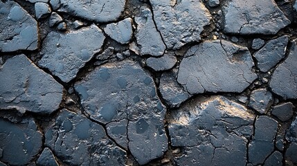 Cracked dark gray asphalt surface texture