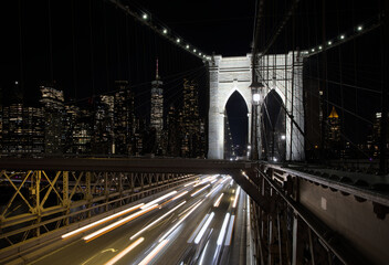 cars driving over the brooklyn bridge at night (light trails long exposure headlights tail lights)...