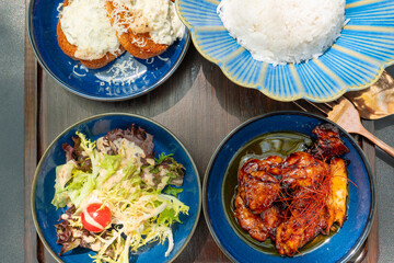 top view american style bbq sauce chicken steak served with rice and salad and bread at horizontal composition