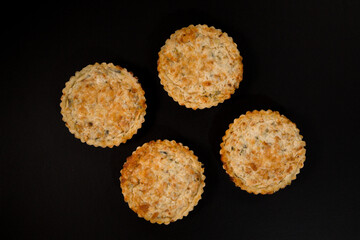 Chicken and mushroom quiche on a black background, top view