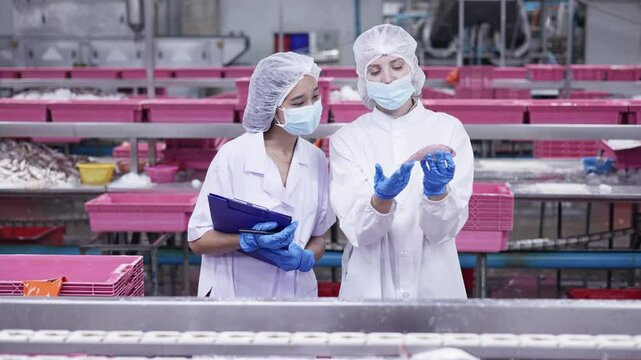 Quality control inspectors in a food processing plant