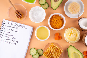 DIY Natural Sunscreen Alternative, Anti-Sunscreen Movement. Natural organic SPF ingredients background with olive oil, coconut oil, cocoa butter, aloe gel, beeswax, carrot seed oil