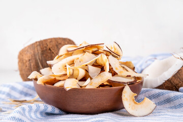 Homemade coconut chips, healthy organic coconut crackers, alternative snack for keto, diet lifestyle, with fresh coconut, copy space