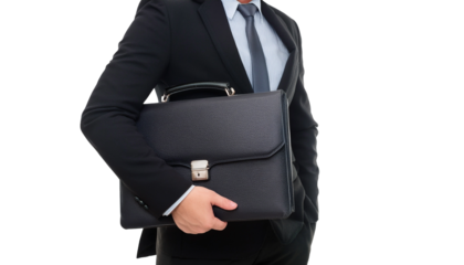 a business man in a formal suit holding a black briefcase,ready for a workday.The man's pose exudes professionalism and confidence, ready for tasks