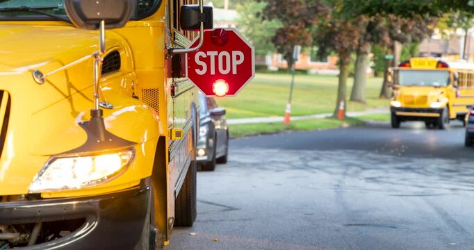 Flashing red lights on a stop sign of a school bus 