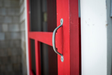 Close-Up of Rustic Red Screen Door Handle
