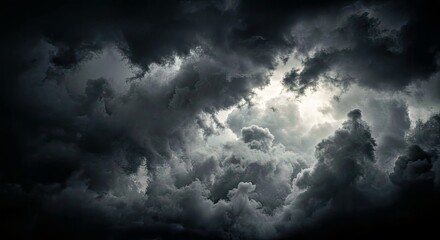 Fototapeta premium A Chaotic, Swirling Mass of Stormy Clouds With Deep Blacks, Sharp Grays, and Glowing White Highlights