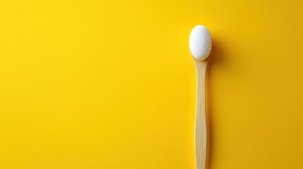 Single Egg on Wooden Spoon, Yellow Background