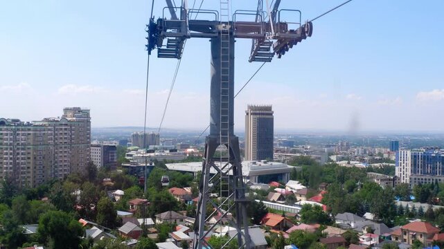 Cable car ride over Almaty. Panoramic cityscape with majestic mountains. Kok Tobe observation deck, Almaty, Kazakhstan