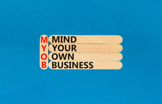 MYOB mind your own business symbol. Concept word MYOB Mind Your Own Business on beautiful wooden sticks. Beautiful blue background. Business MYOB mind your own business concept. Copy space.