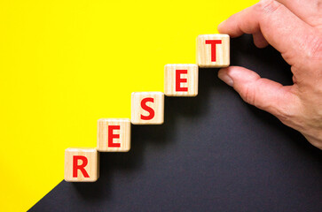 Reset symbol. Concept word Reset on beautiful wooden blocks. Beautiful yellow and black background....