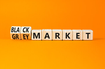 Black or grey market symbol. Concept words Black market or Grey market on beautiful wooden blocks. Beautiful orange table orange background. Business black or grey market concept. Copy space.