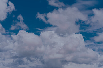 Naklejka premium Puffy clouds in blue sky.