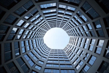 tall building with many windows and a cross on the side