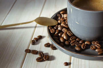 A cozy cup of coffee on a wooden table, with beans and a golden spoon. A perfect scene for coffee lovers.
