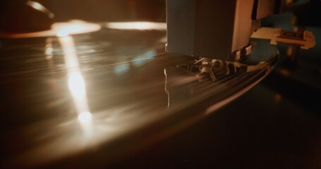 Macro Close Up of Needle Gently Scratching Grooves, Playing Song or Authentic Analog Music on Vinyl Record Player. Vinyl Record Spinning On Vintage Turntable. Retro Sound System with Nostalgic Vibe.