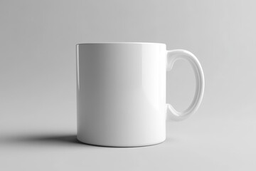 Obraz premium A simple white ceramic mug displayed on a plain surface
