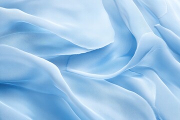 Obraz premium An abstract image of light blue feathers gently resting on a smooth background, with soft shadows casting across the delicate textures of the feathers. The light creates a subtle gradient effect